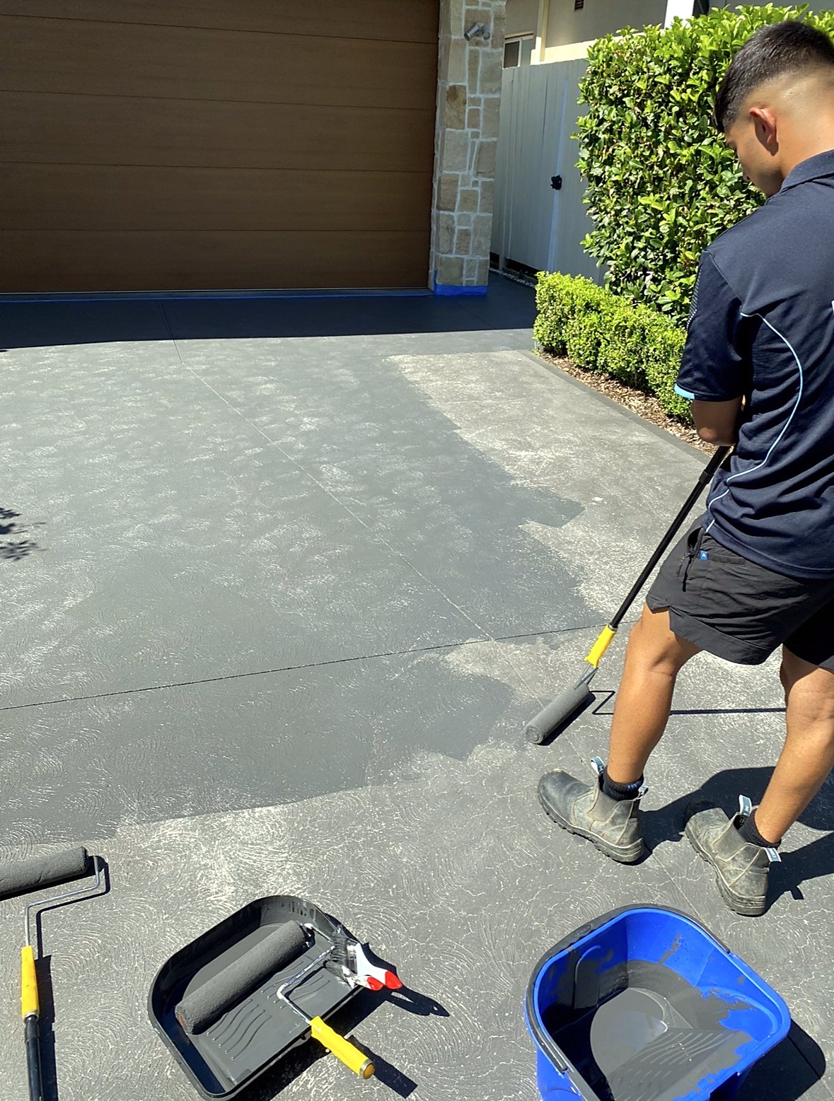 PureFlow team member sealing a driveway